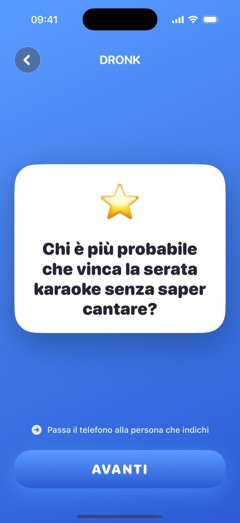 Chi è più probabile nell'app Dronk: una carta domanda bianca con Who's most likely to win karaoke night, without being able to sing? sopra il suggerimento Pass the phone to whoever you point at e il pulsante Next (screenshot della versione inglese)